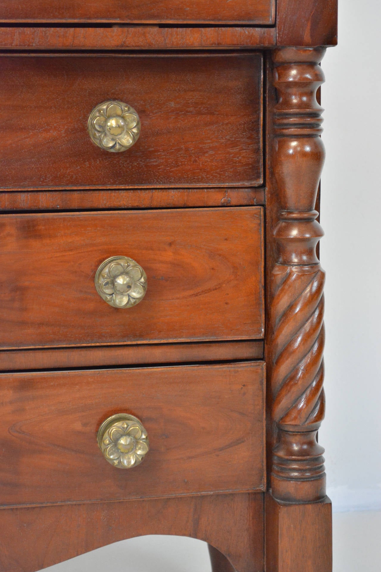 A lovely flame mahogany chest of  four drawers with a two drawer superstructure. With Scrolled apron and carved half columns, raised on turned feet. Mahogany veneers and solids.