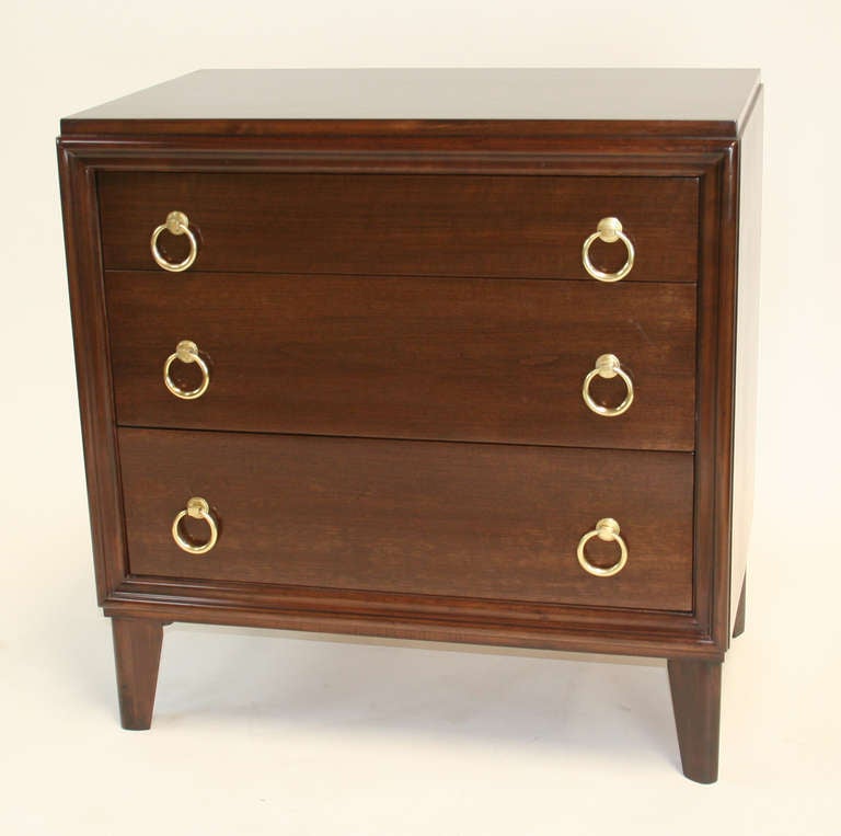 A lovely small scale three drawer chest in cherry with a dark walnut finish. Picture frame front, inset, canted legs lend this piece an air of sophistication. Original brass pulls.