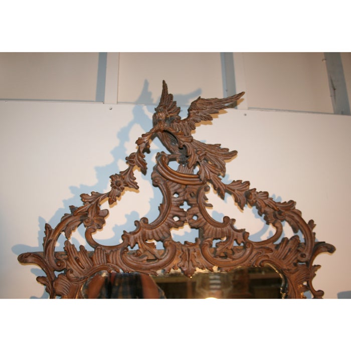 Exuberantly carved Chippendale style mirror of large size. Great presence. Asymmetric carving centering on an eagle with garland. Italian.