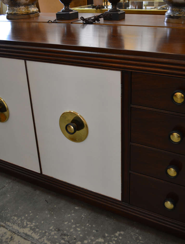 Wonderful credenza or sideboard byPaul Frankl for Johnson Furniture Co, USA, Dated 1940s. Dark stained mahogany case with lacquered cork doors. Original brass and painted wood hardware. Brass label and branded Johnson Furniture Co. mark.