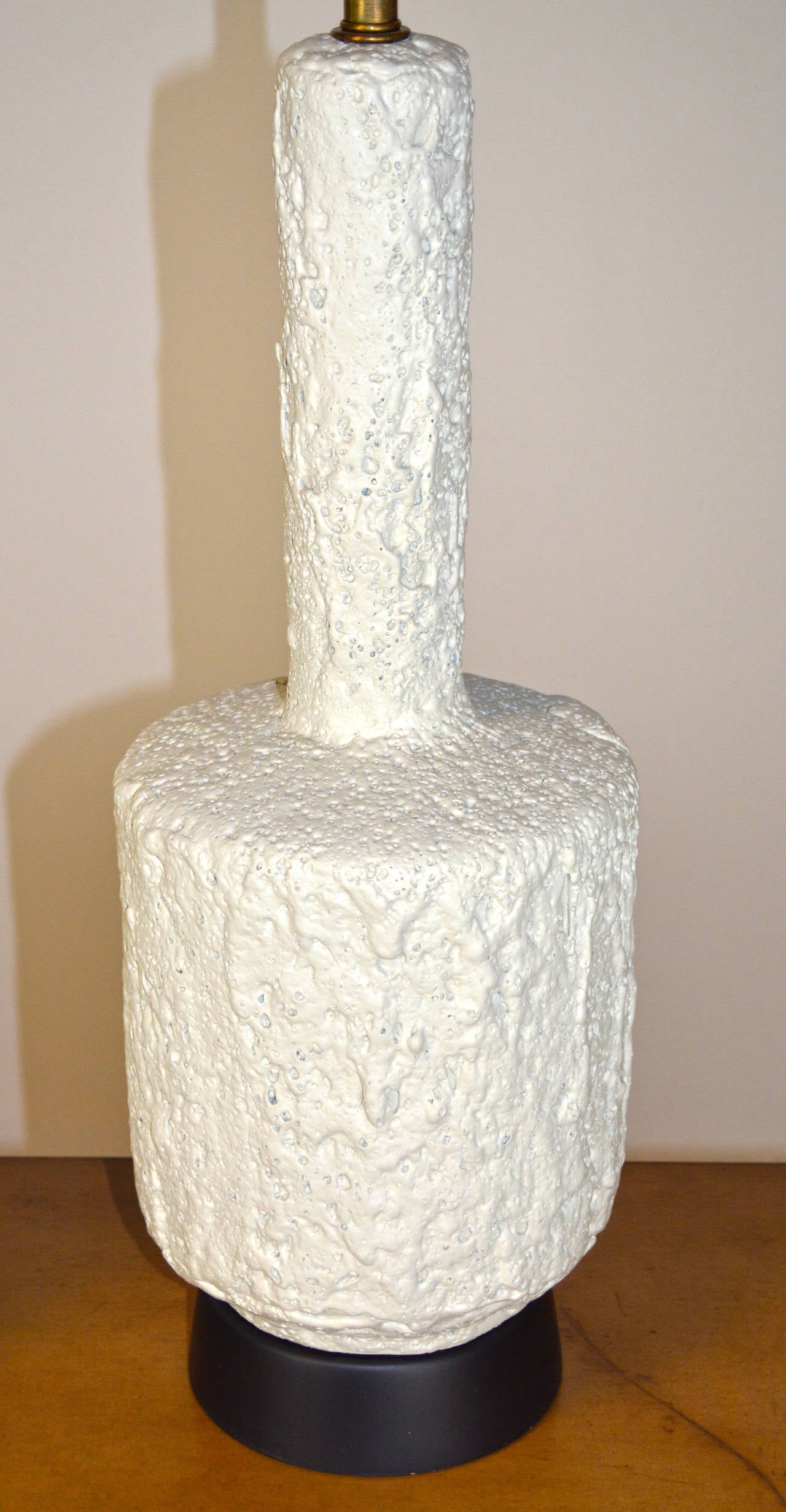 A lovely plaster lamp with a rough texture 'lava' finish, on new black wood base. Shade not included, for display only.