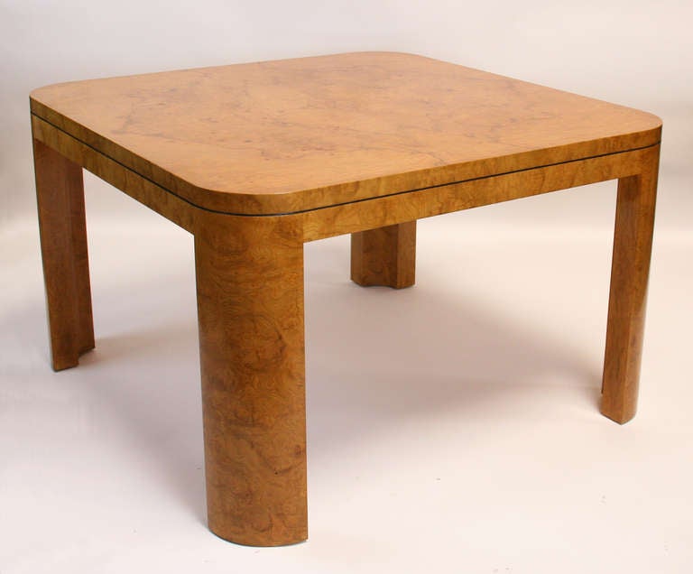 Elegant burl wood game or dining table with radius legs and bookmatched veneer top. Custom piece from the early 80's in the style of Karl Springer