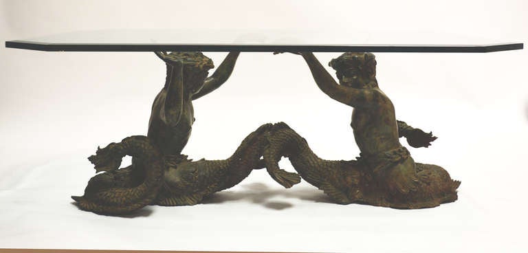 Bronze figure of two Mermen supporting a glass top. Great detail. Good patina.