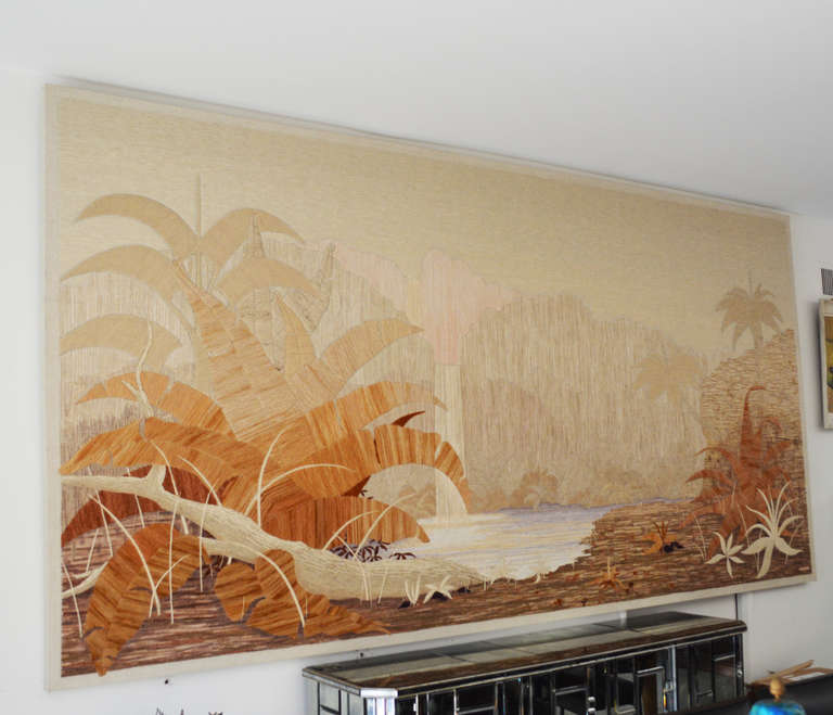 An exceptional example of weaving skill - a monumental panel depicting a tropical scene with mountains and a waterfall in the distance. Different yarns were used to create sheen and texture in a subtle palette of creams and warm browns. Signed by