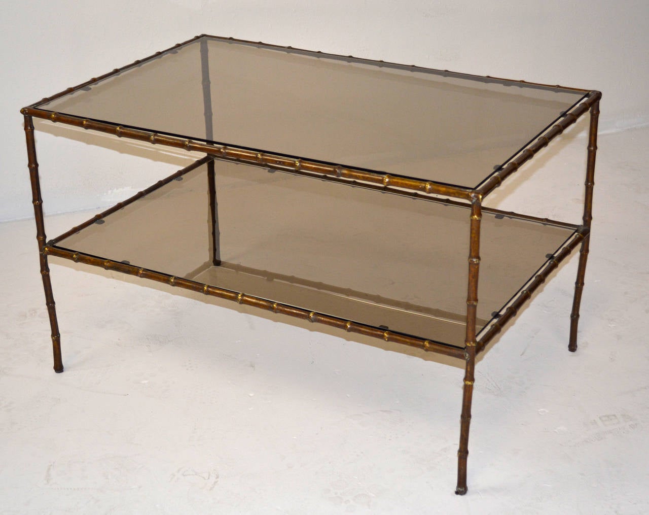A pair of large-scale side tables with hand-forged bronze faux bamboo frames supporting a bronze glass top and shelf. Exceptional quality in the manner of Maison Baguès and Maison Jansen.