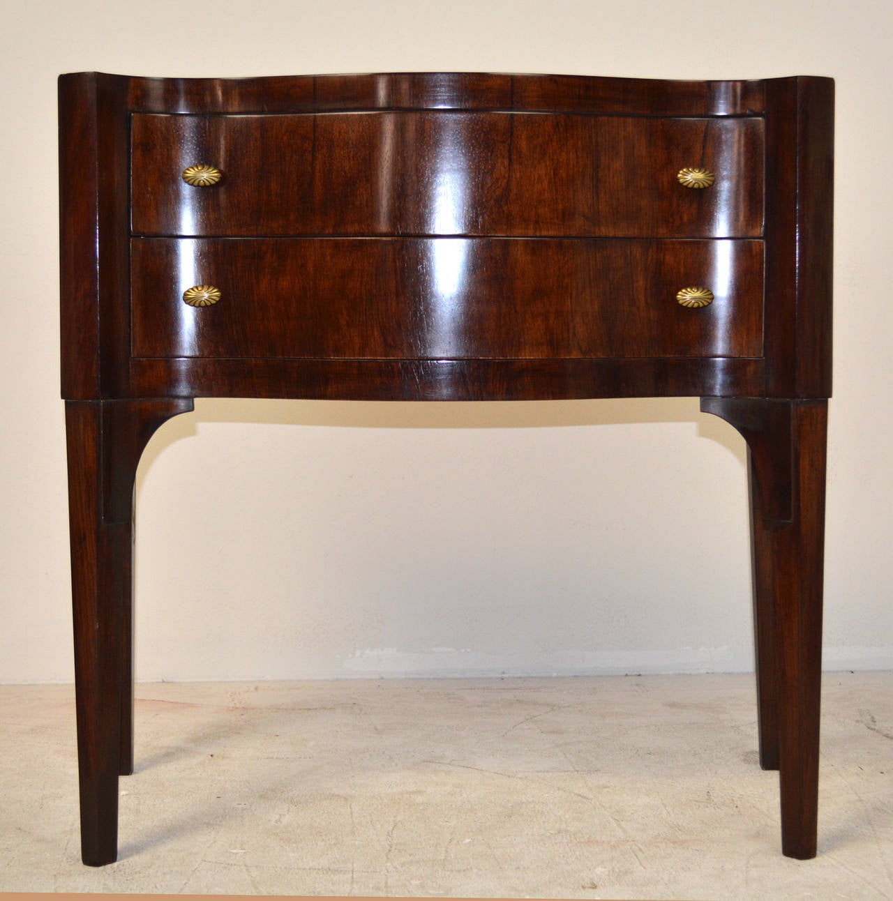 A rare rosewood commode designed by Edward Wormley for Dunbar. Small-scale and deeply sculpted front with tapered canted legs. Dunbar model no. 6335.