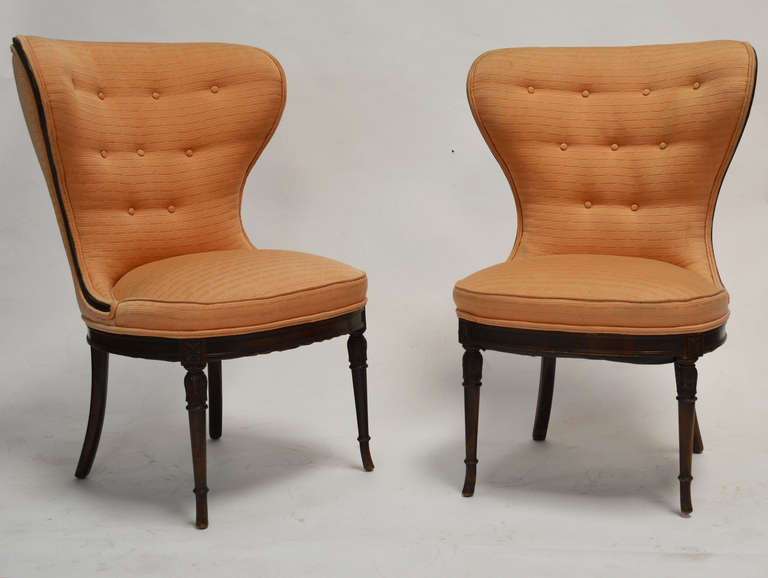 A sculptural pair of balloon wingback chairs with carved legs in the manner of Grosfeld House. Two sets of chairs four available.