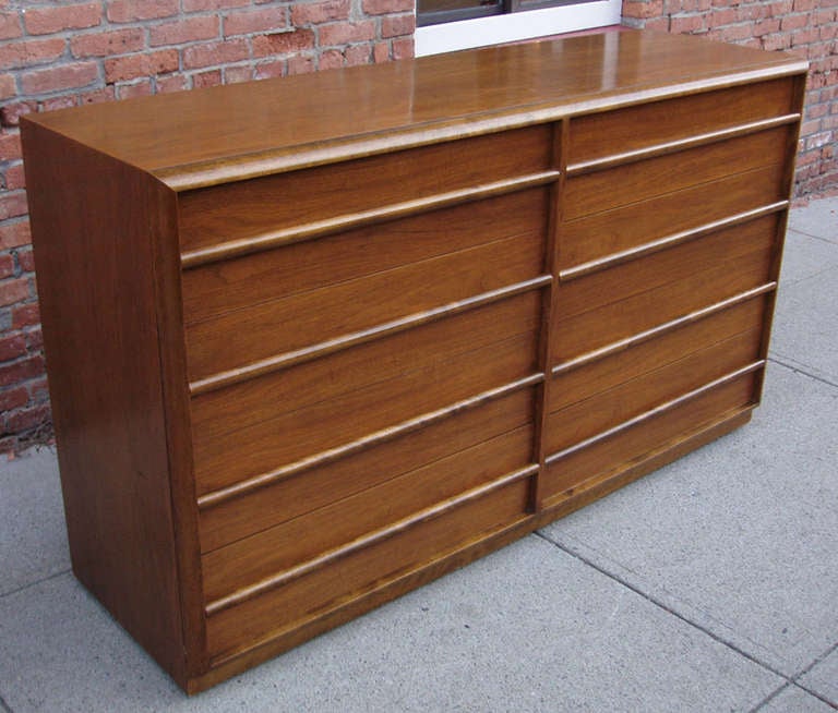 Exceptional 8 drawer Gentleman's chest in walnut, designed by T.H. Robsjohn-Gibbings for Widdicomb. Large case with a deep beveled frame, having 8 drawers with rounded dowel drawer pulls. Many drawers divided, including valuables trays. retains