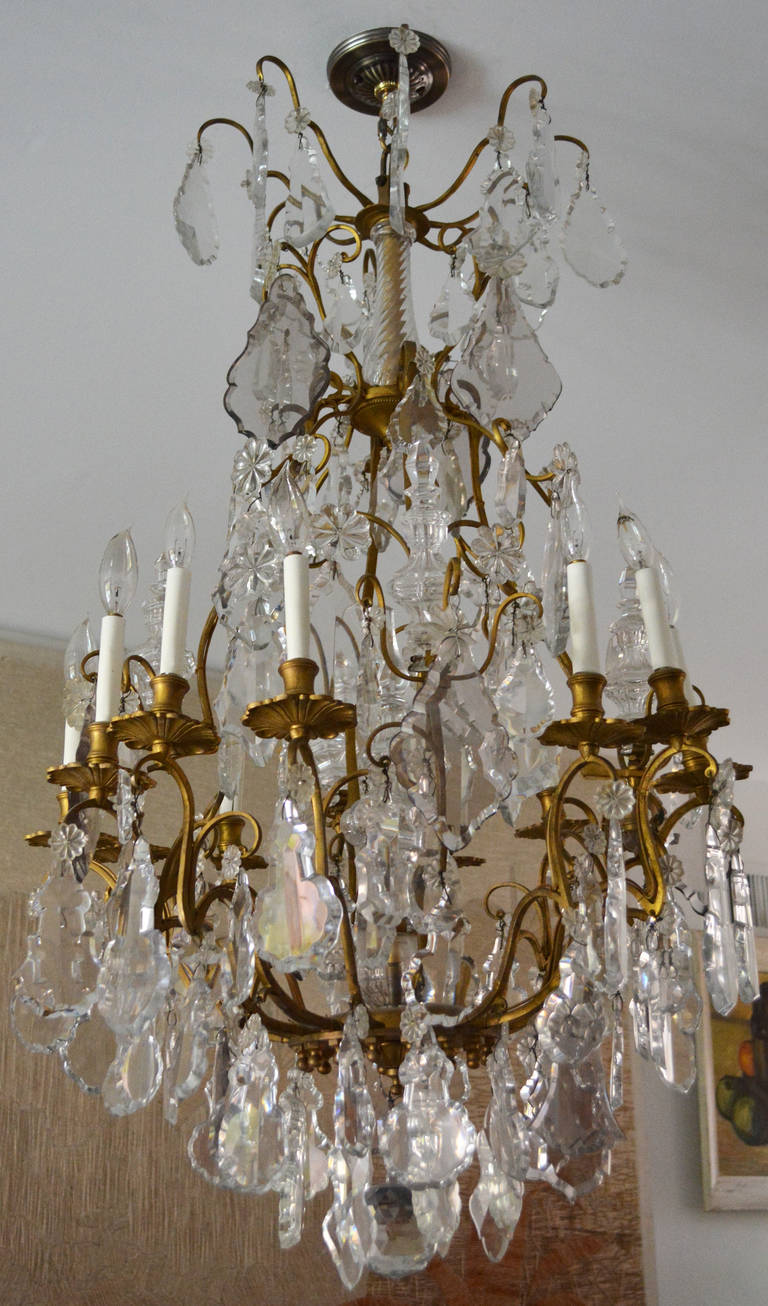 Elegant twelve-light Louis XV style chandelier of gilt bronze with large crystal plaquettes and spires from the mid to late 19th century.