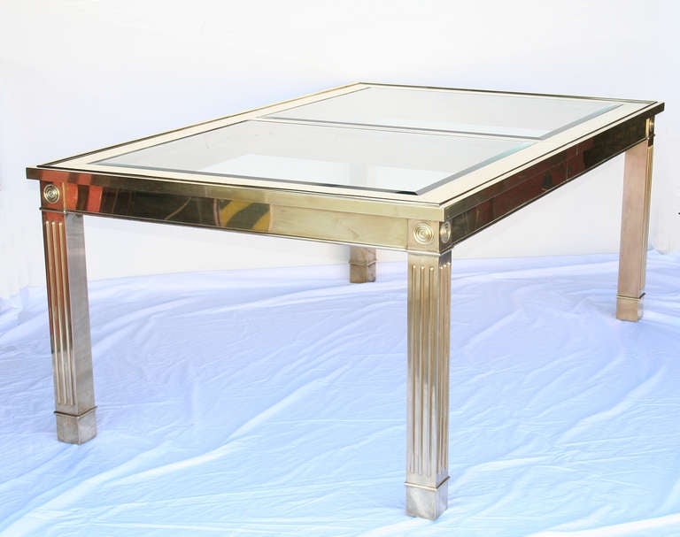 Extending Dining table in brass with inset beveled glass tops. Classical detailing on legs. Great quality. Has one 34