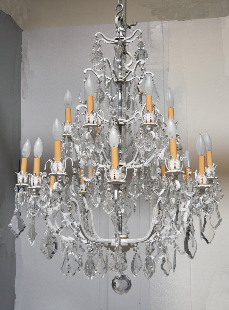 A stunning 18 light crystal chandelier on a white painted metal frame. Uniquely updated to work in a traditional or contemporary setting. French or Italian