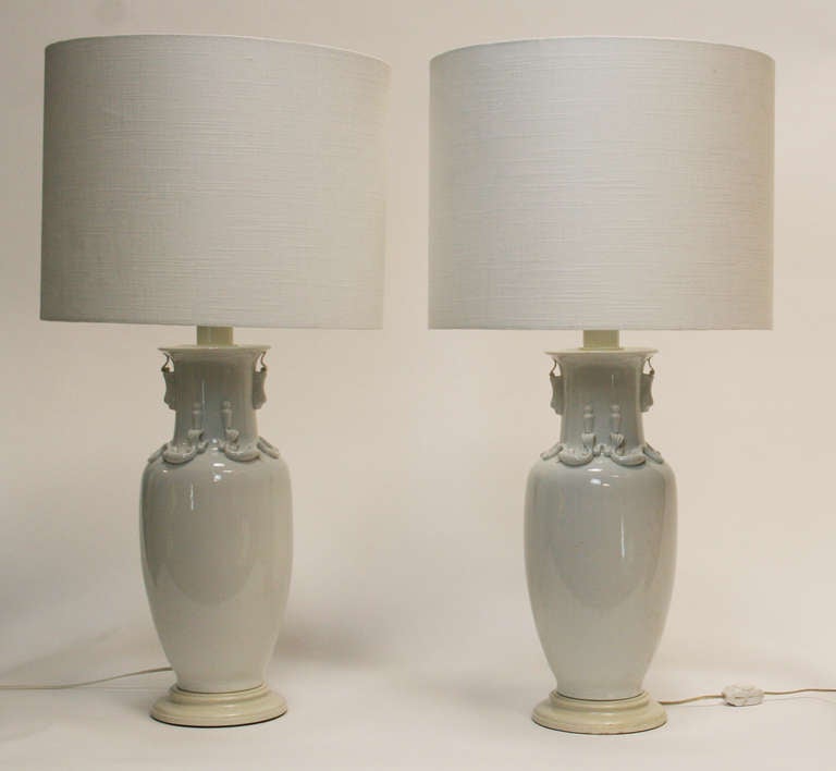 Truly exceptional blanc de chine lamps with painted wood base and mounts in the manner of William Haines and Paul Laszlo. Large scale with fine detailing. Custom shades included. Fitted with adjustable double cluster sockets. Socket can be adjusted