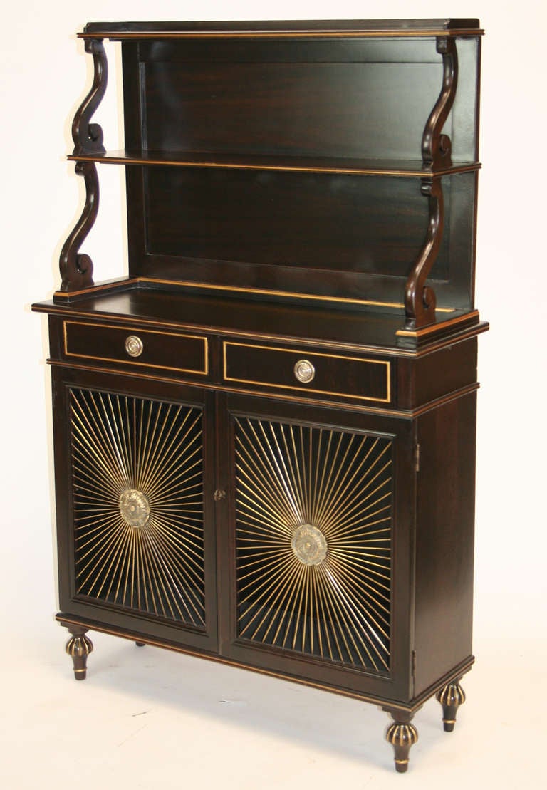 Lovely Regency Revival chiffonier / bookcase secretaire with two drawers over two doors with brass radial screen. Upper case has two shelves and scrolled supports. Gilt accents to ebonized case.