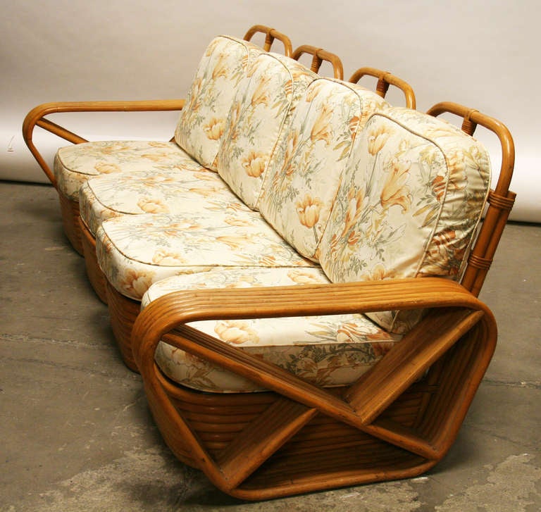 A large set of Paul Frankl style rattan made by Tochiku Industries in Japan, circa 1950. Consisting of 11 pieces including 2 armless and 2 side arm sectional pieces, two lounge chairs and an ottoman, a square corner table, round coffee table, and 2