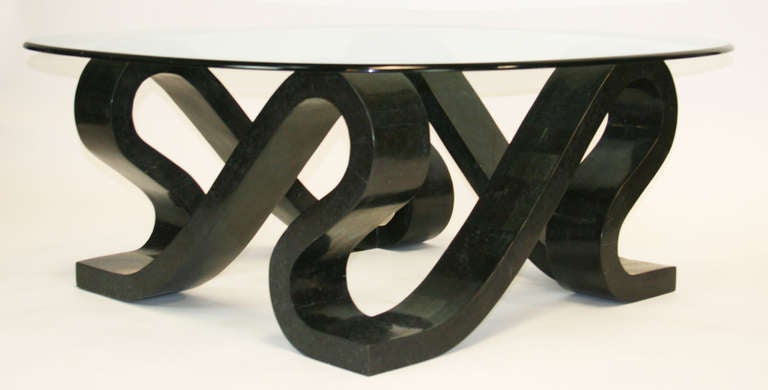 Sculptural coffee table with undulating ribbon base made from tessellated marble tiles. Excellent quality. Glass top with beveled edge. Base is 32