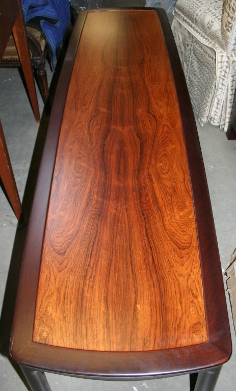 Rosewood and ebonized mahogany coffee table by Edward Wormley for Dunbar. Retains its original paper and metal tags. Excellent grain in bookmatched rosewood top. Sculptural legs that were hand carved.