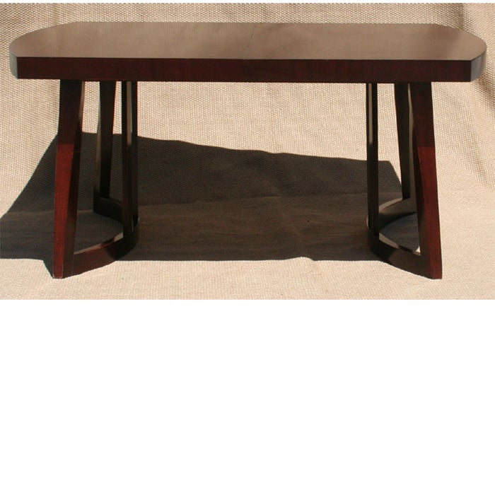 Moderne dining table with beautiful curved sculptural legs and ends in mahogany. 3.5