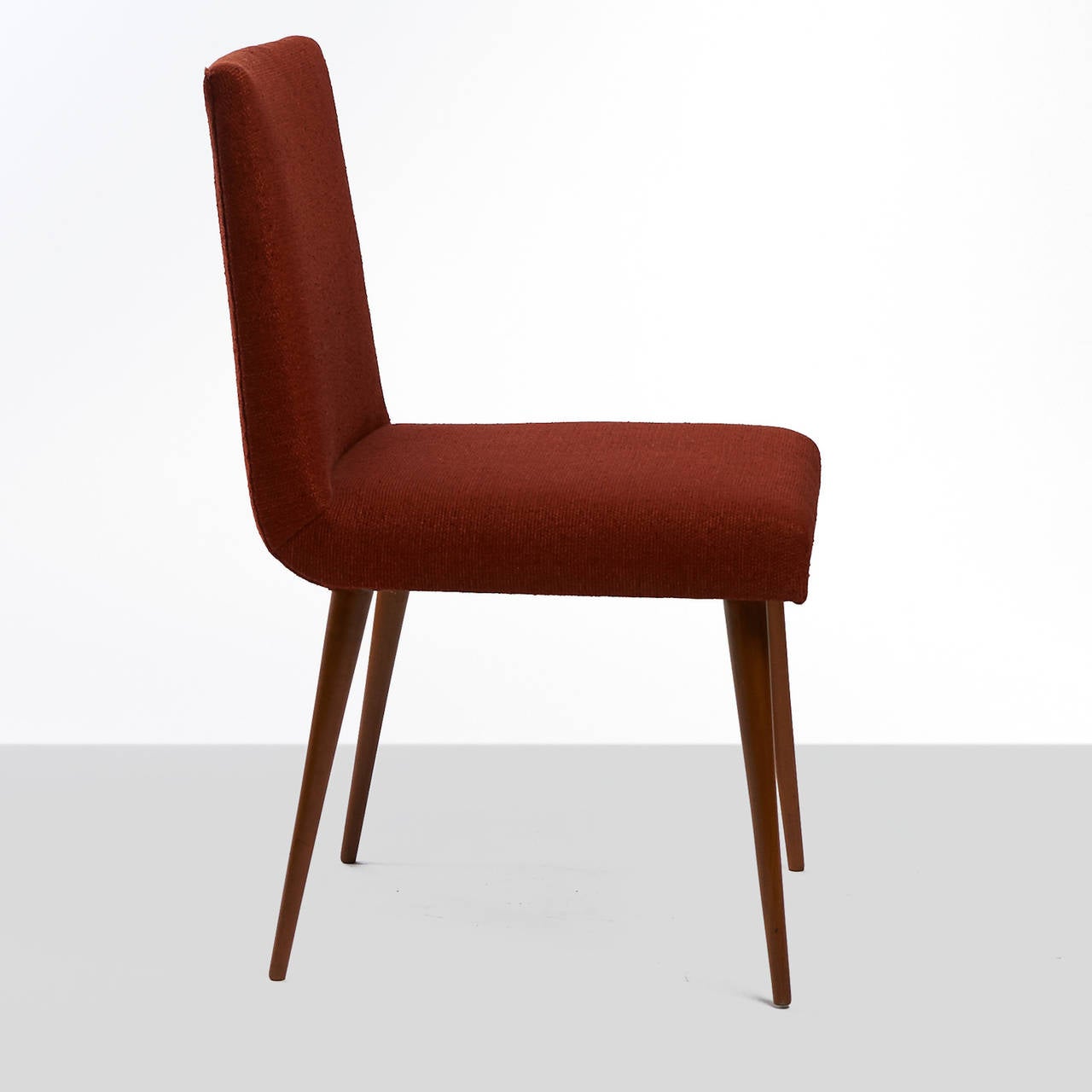 A side chair by Joaquim Tenreiro. Original upholstery and stiletto legs of
Brazilian mahogany.