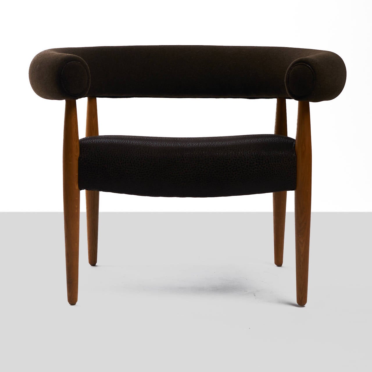 A pair of round easy chairs by Nanna and Jorgen Ditzel. Seat upholstered in an embossed boar print leather with contrasting cashmere arms. Legs of oak. Model FM2611.