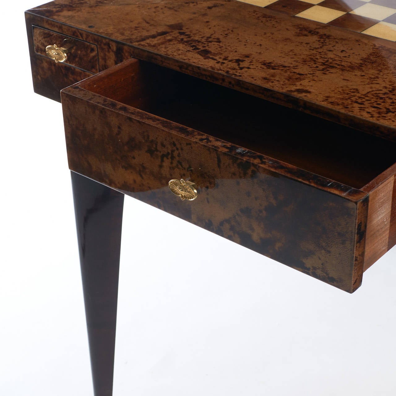 A parchment game table with a chess board surface. Drawer for game pieces and four slide-out cigarette trays. Please note, two of the brass dishes are missing.