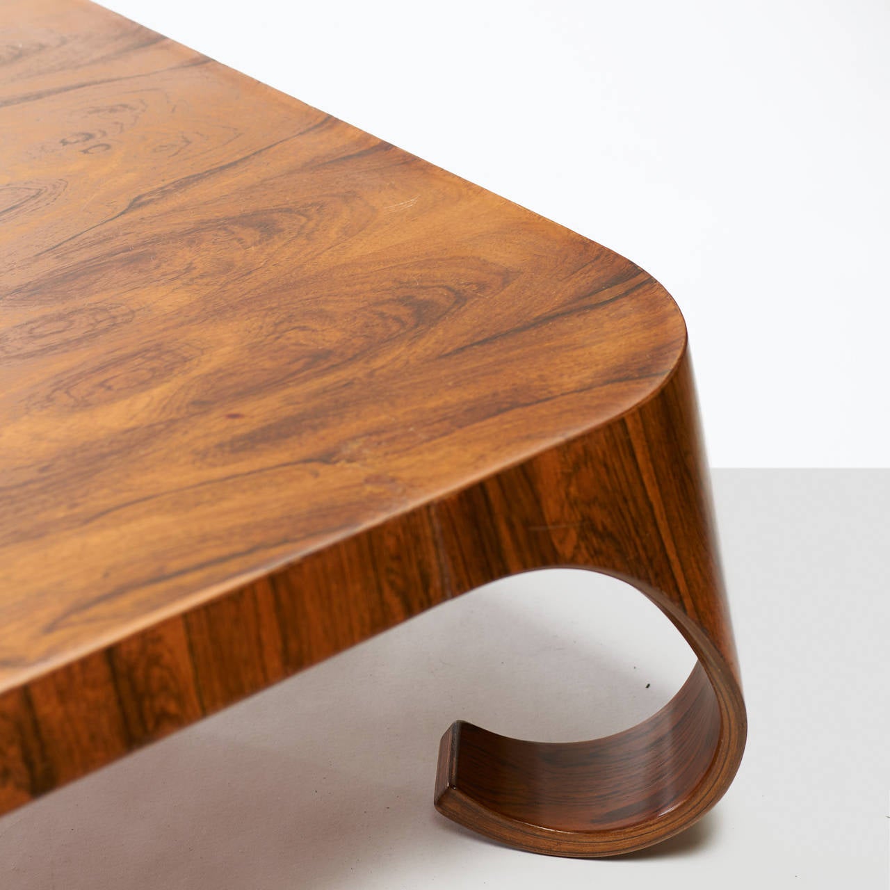 A coffee table by Isamu Kenmochi in bent Brazilian rosewood with curved legs. Signed with applied manufacturer's label to underside: [Tendo]. Literature: Japanese Modern, Mori, pg. 143.