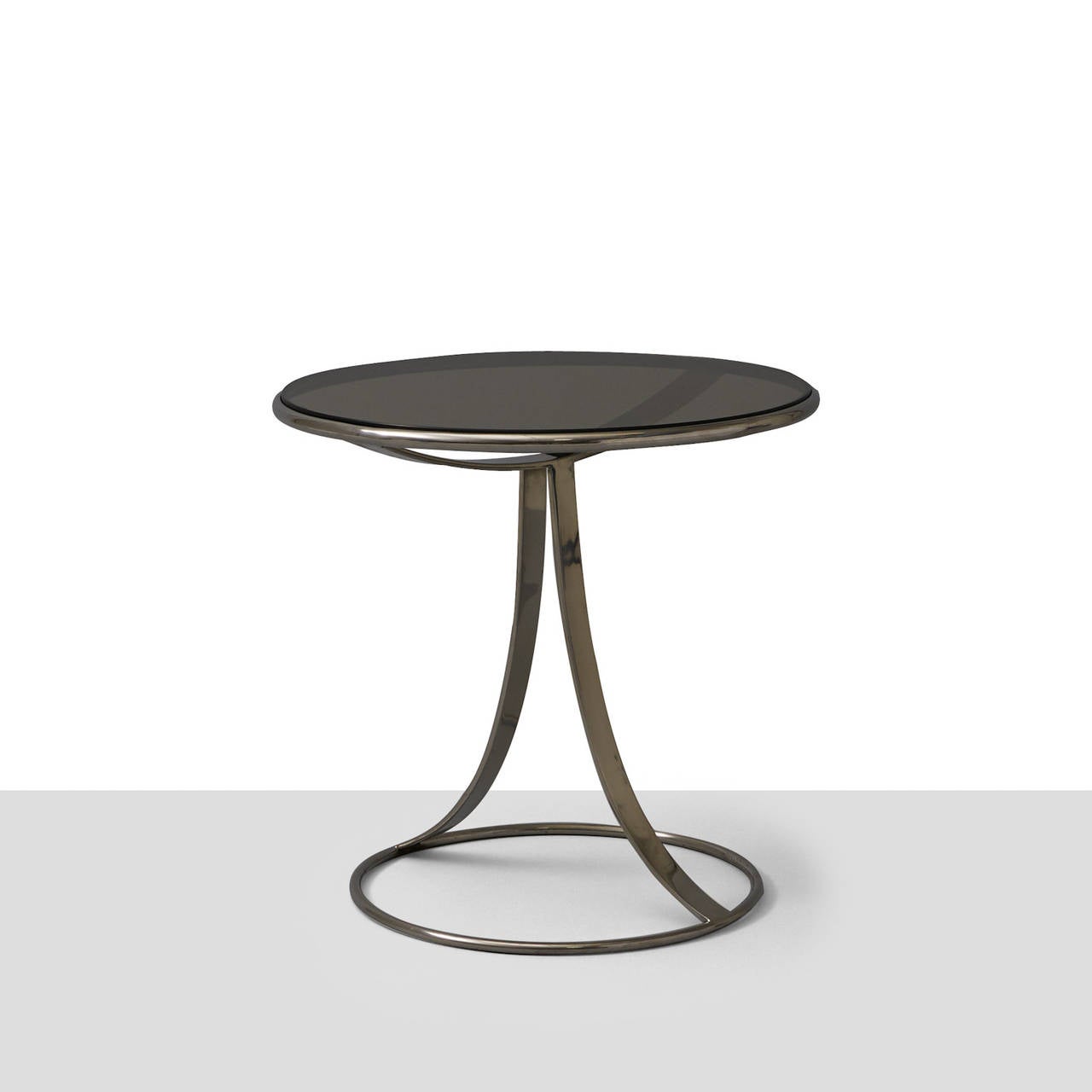 A pair of occasional tables by Gardner Leaver for Steelcase. Steel base and smoked glass table top.