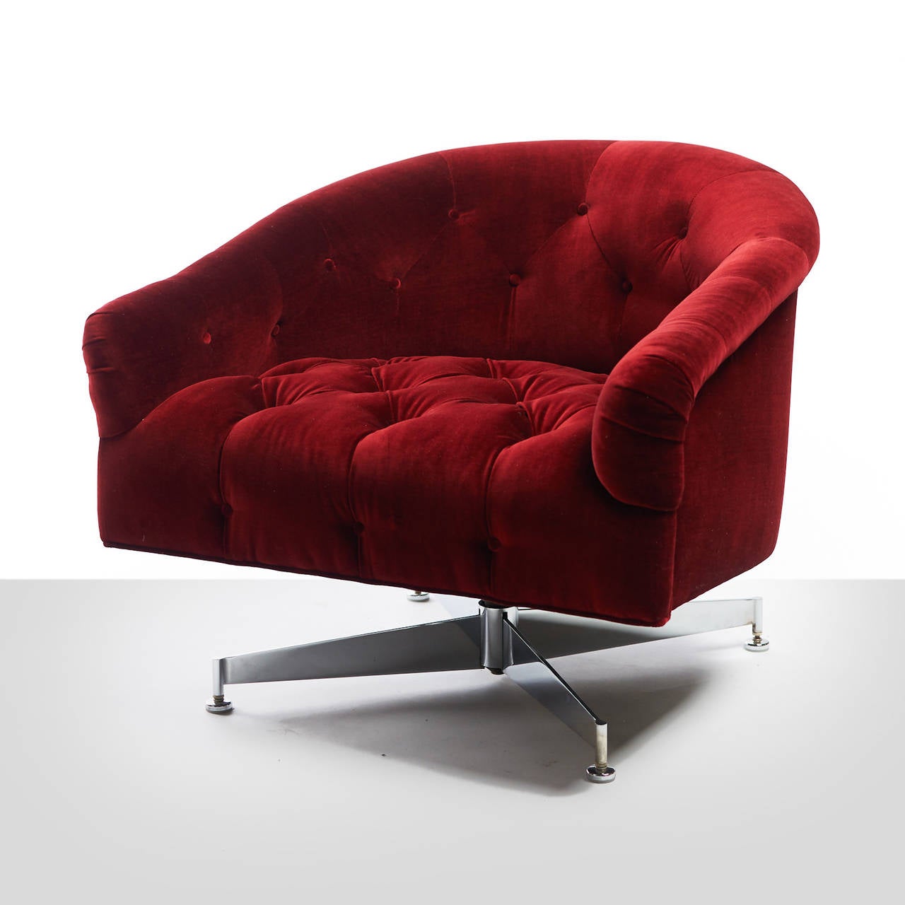 A pair of button tufted swivel lounge chairs by Ward Bennett. Recently restored in a crimson velvet. Steel four-leg base.

One chair has been sold and the single available.