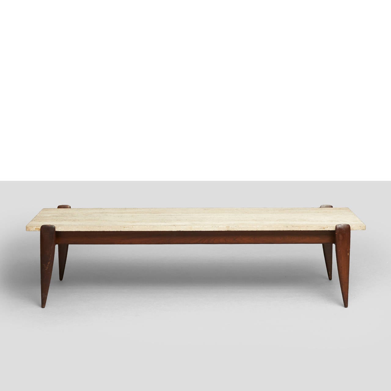 A walnut coffee table with travertine top by Gio Ponti, stone stamped 