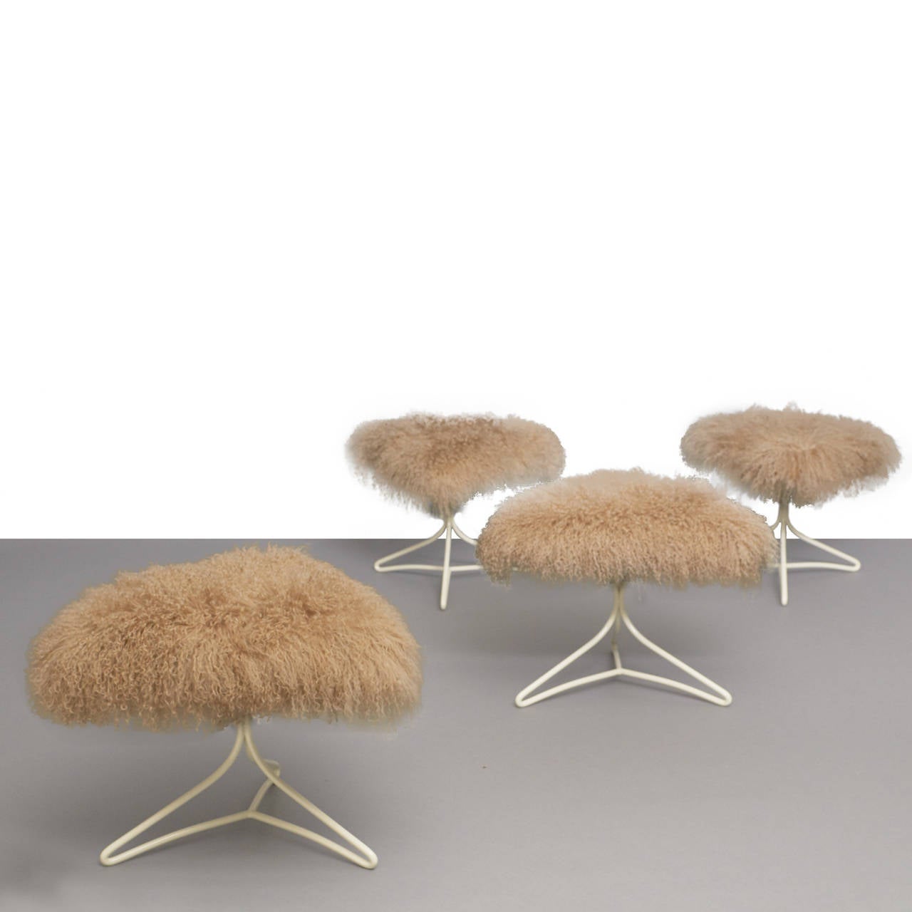 A group of four stools by Vladimir Kagan. Each featuring a soft taupe colored Himalayan goat hair top and off-white, powder-coated base.