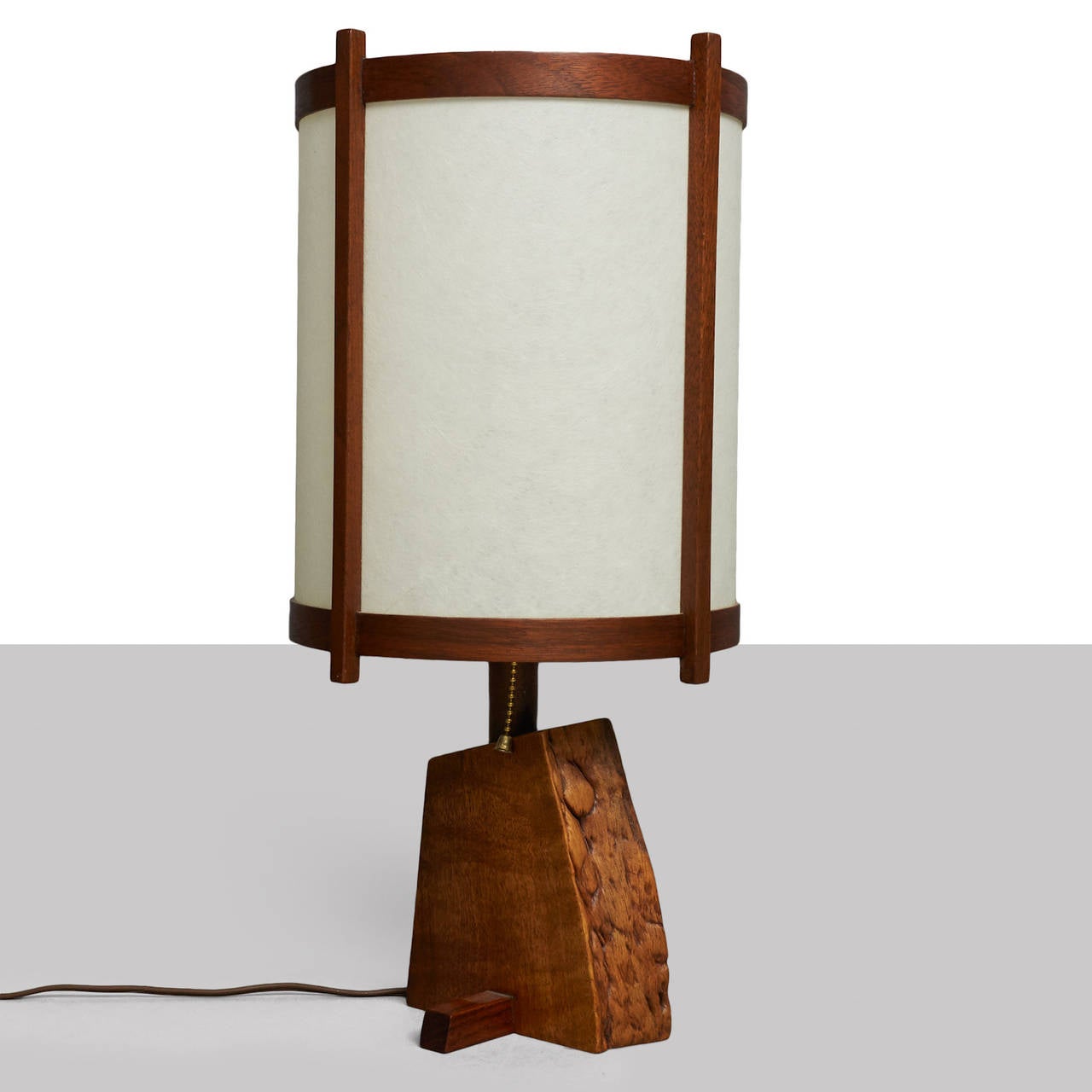 A walnut and rosewood lamp by George Nakashima with its original shade.