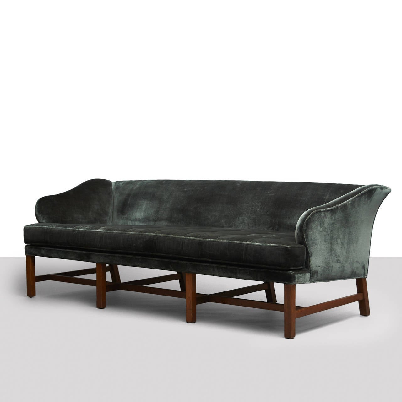 A sofa by Edward Wormley for Dunbar. Restored in a teal silk velvet with two down filled throw pillows and walnut legs.