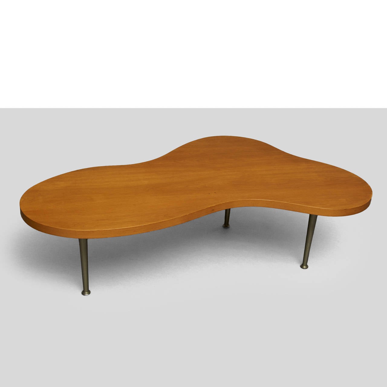 A Biomorphic maple coffee table for Widdicomb Furniture. Maple top
and aluminum legs. Retains the original Widdicomb Label.