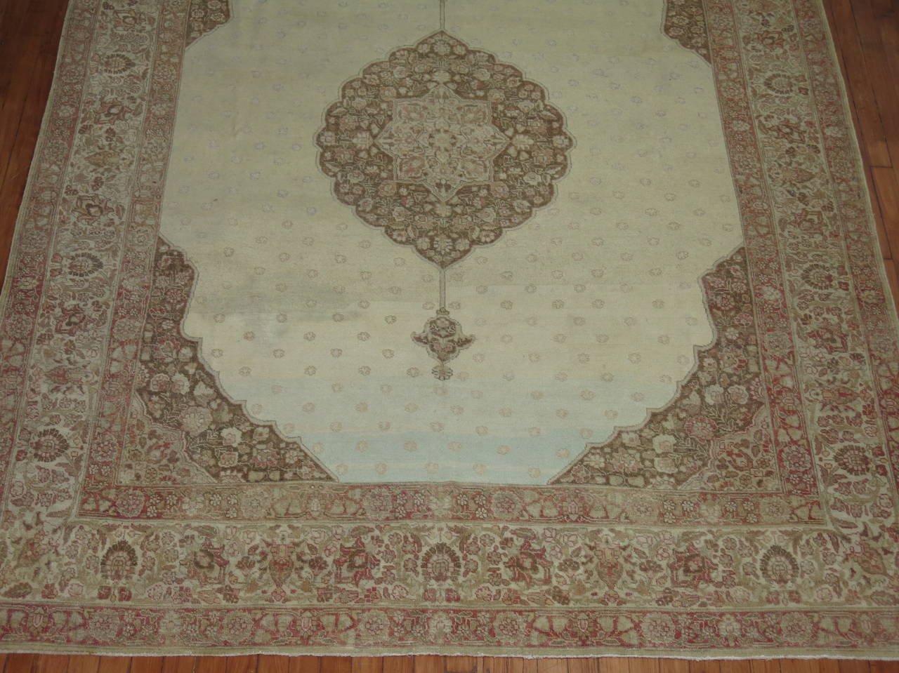 Late 19th century Persian Tabriz rug with a Classic medallion and border on an icy blue field.