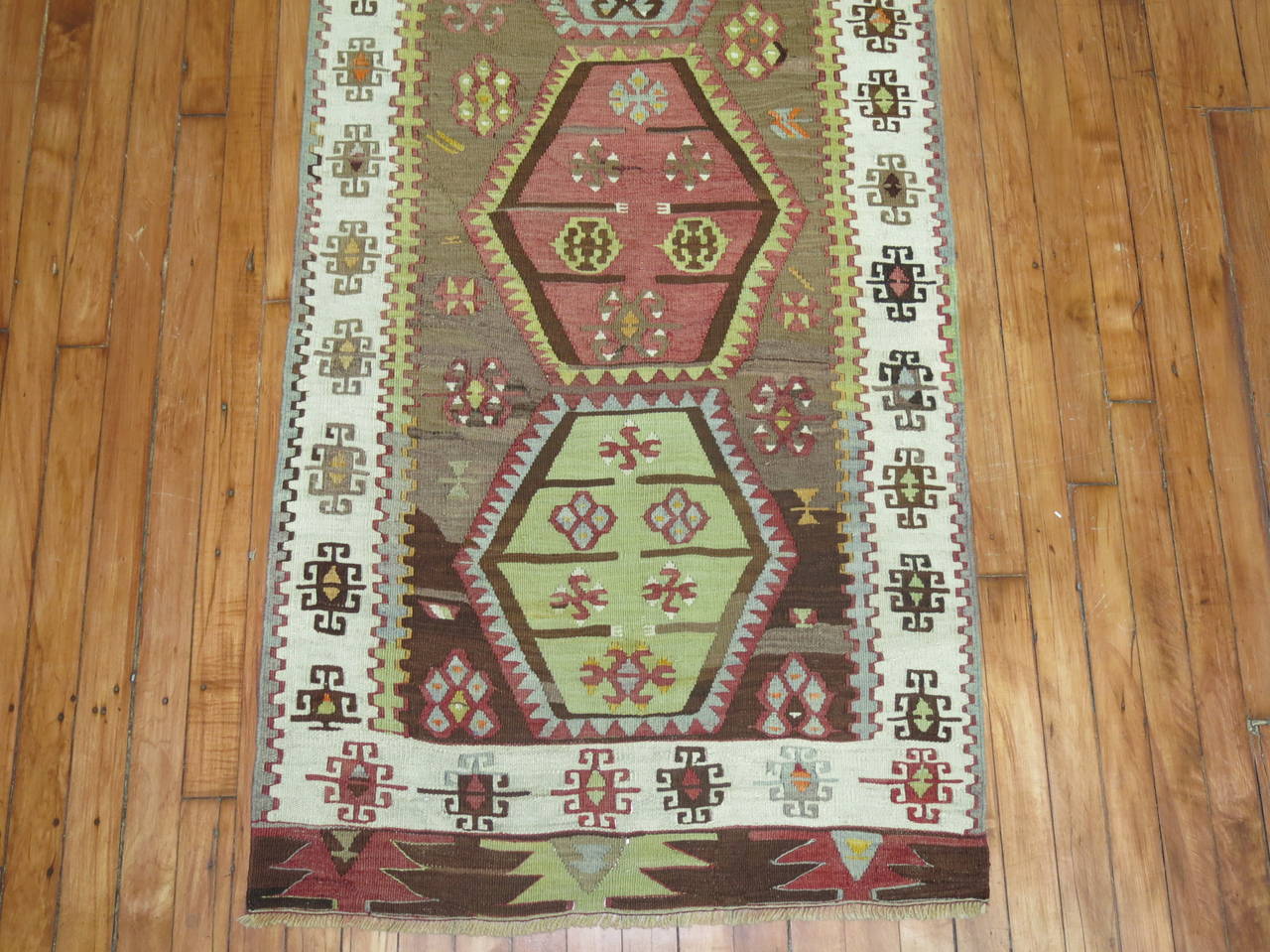 Marvellous long and narrow Turkish flat-weave runner with a geometric design on a cocoa brown field.