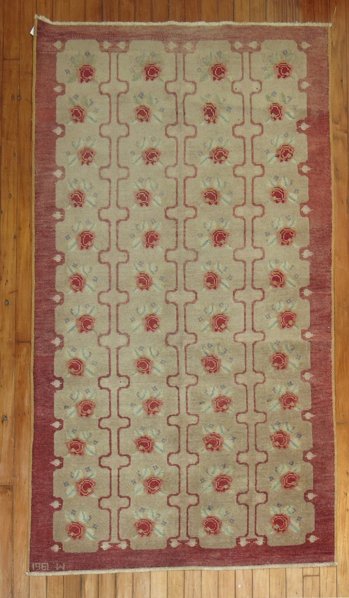 Vintage Turkish Konya rug with repeating floral motif design in raspberry tones on a brown ground. Date found on end border, dated 1961.

Measures: 3'5