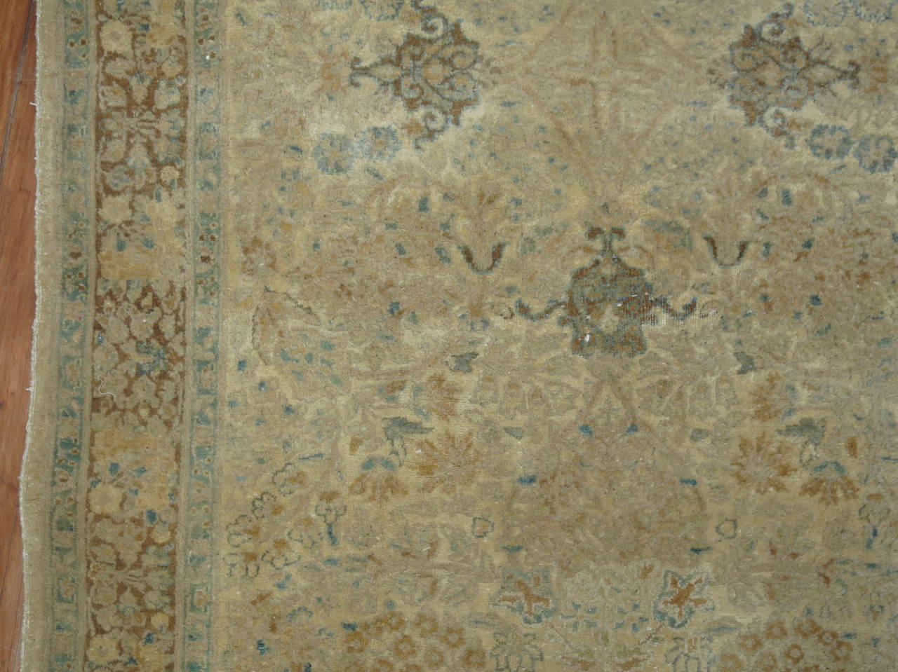 An elegant antique Persian Kirman (Kerman) runner with predominant khaki brown and celadon accents set on a shiny cream ground. Extremely Rare size to find from this time period and region.

2'10'' x 11'8''