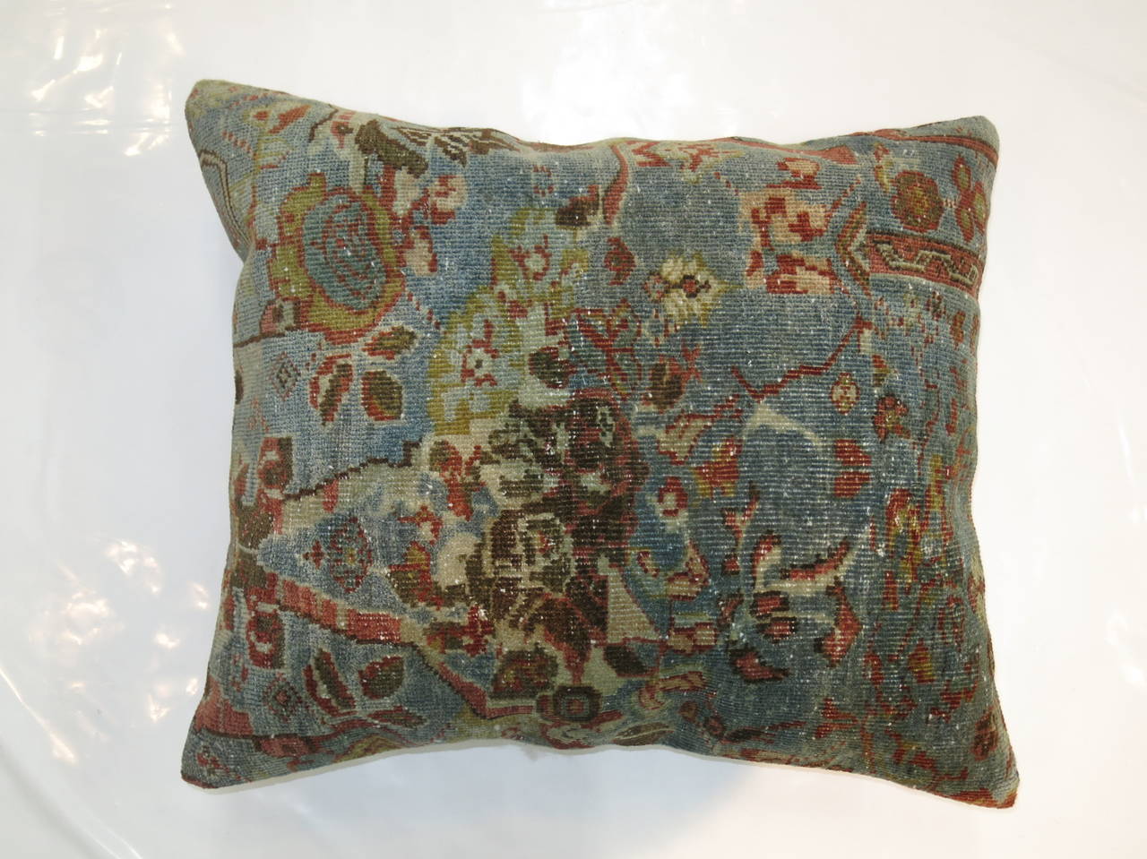Large pillow from an antique Persian Sultanabad rug in light blue and brown measuring 23'' x 25''. Backed in blue satin.