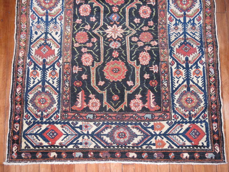 A small square size early 20th century finely handcrafted Persian Malayer rug. An array of colors on a black brown ground 

Measures: 3'6'' x 4'.