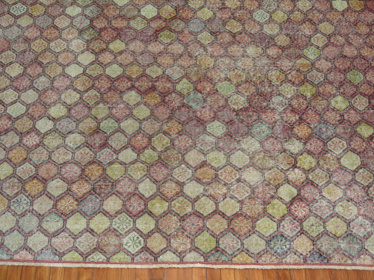 A Mid-Century room size Turkish deco rug with an all -over diamond shaped motif on a raspberry background.

Measures: 8'2'' x 10'5''.
