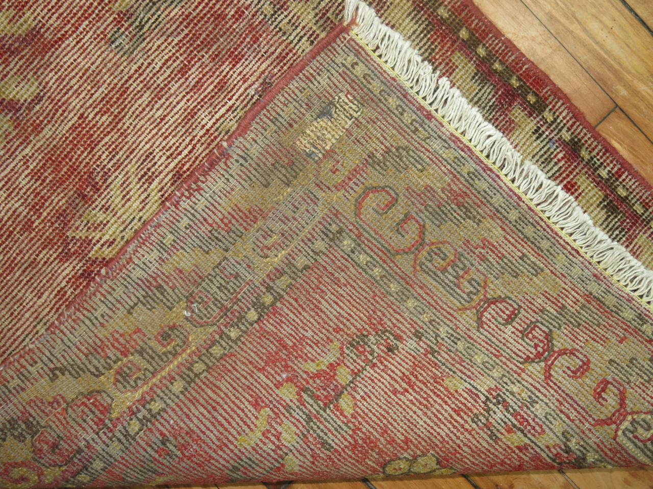 Rare size narrow khotan runner in faded chinese red