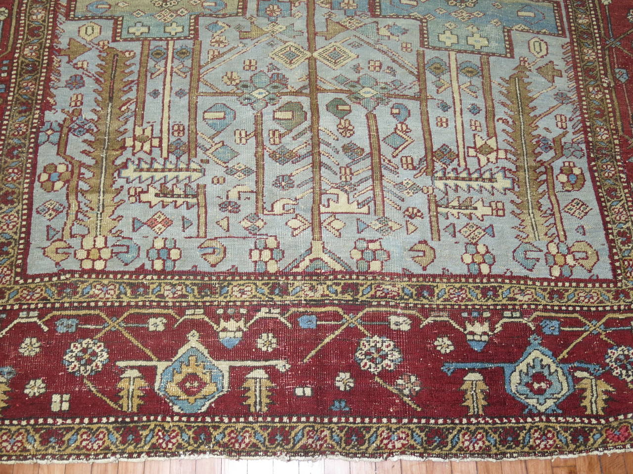 A Persian Heriz rug with a grotesque all-over soft blue geometric motif throughout.