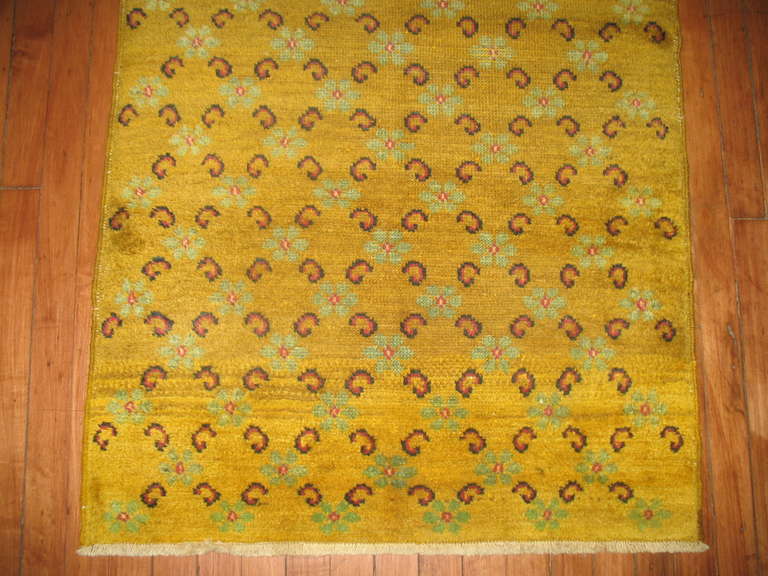 A handmade Turkish anatolian rug in a sunny yellow shade.
