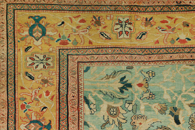 A late 19th century antique Persian Sultanabad rug. Turquoise field with a mustard border.