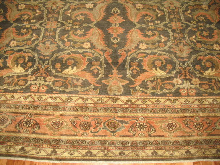 An early 20th century room size Malayer rug with dominant shades in brown and orange

Measures: 10'8'' x 13'4''.