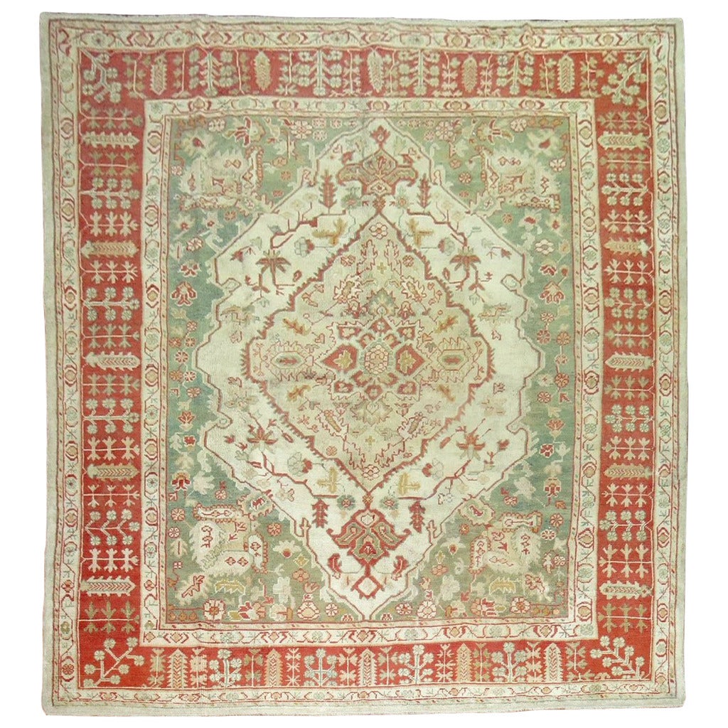 An early 20th century room size antique Turkish oushak rug

Measures: 10'3'' x 13'.