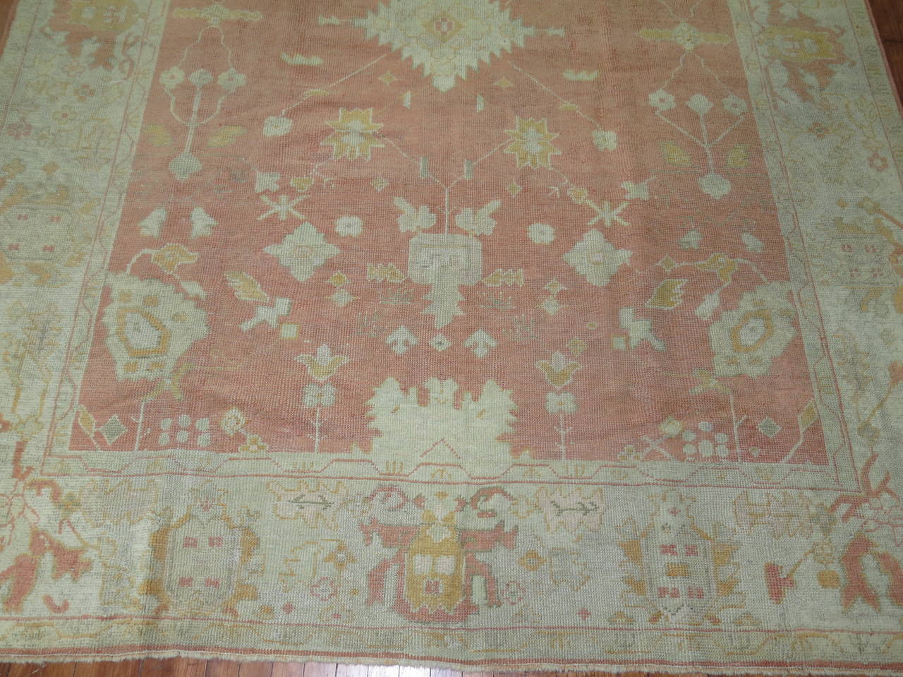 Early 20th century Turkish Oushak rug with a soft peach all-over palette.