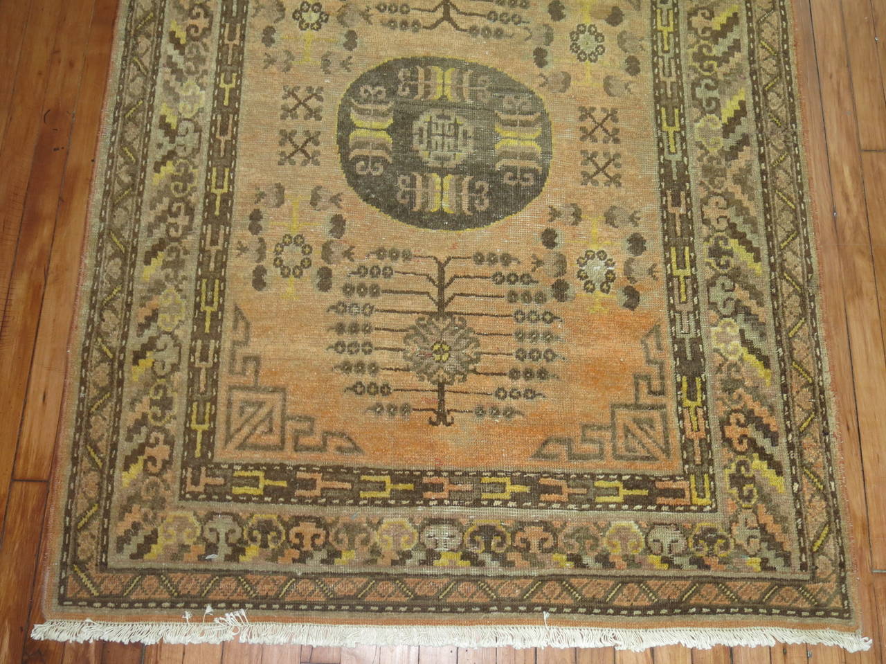 Early 20th century, Khotan rug with cantaloupe colored ground.