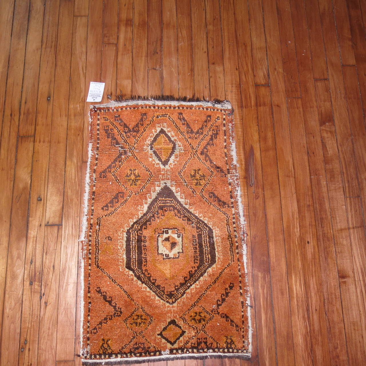 Mid Century abstract Moroccan Rug with an orange peel colored background.