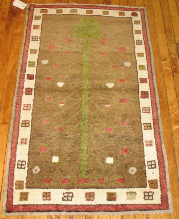 A fascinating small Turkish rug featuring a planted flower tree surrounded by a thin ivory border with small square-shaped cubes. We love how the weaver used very interesting elements when constructing the piece.

Measures: 2'6