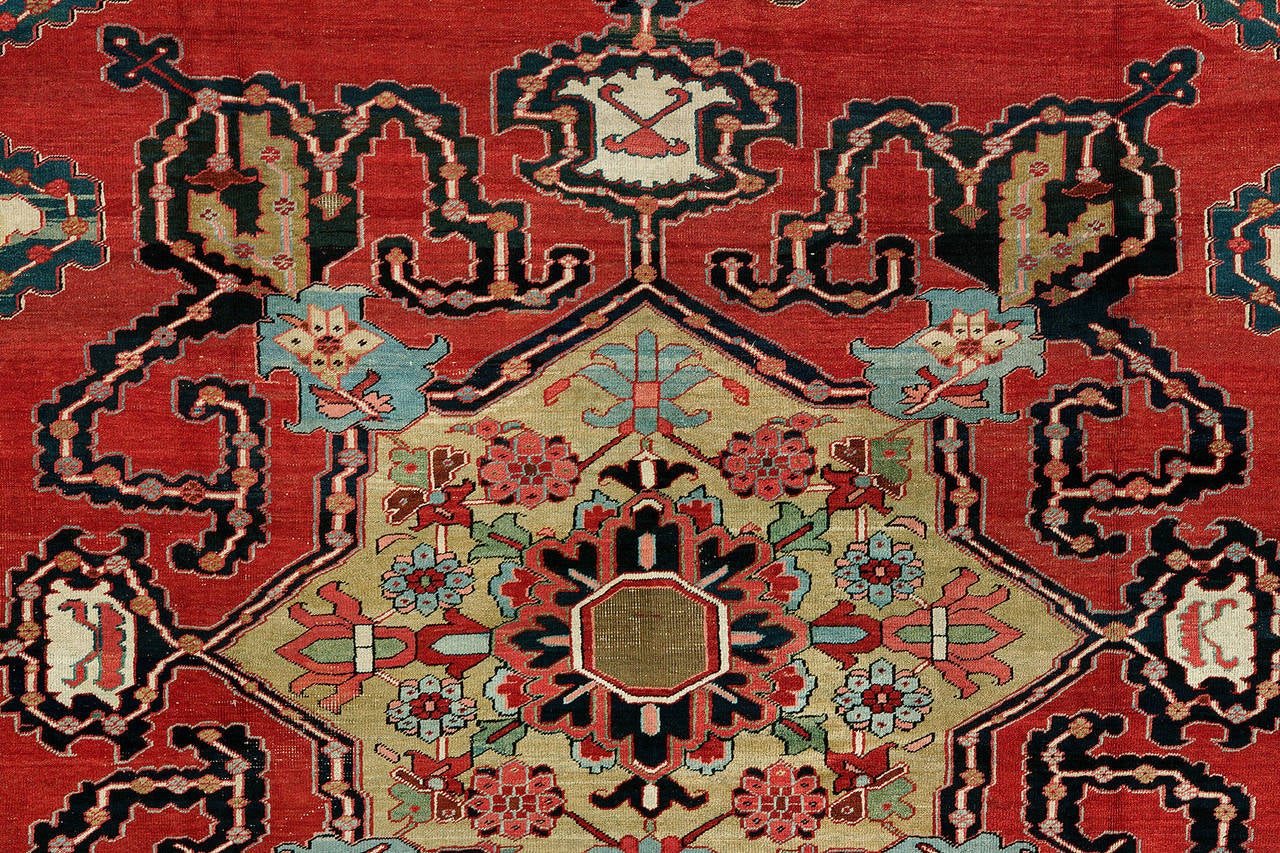 An absolutely exquisite rare size 19th century antique bold Persian Serapi rug.

14'3'' x 18'10''

The finest antique Persian Serapis are geometric or stylized floral in design. The great majority of 19th century Serapi rugs are ennobled by a